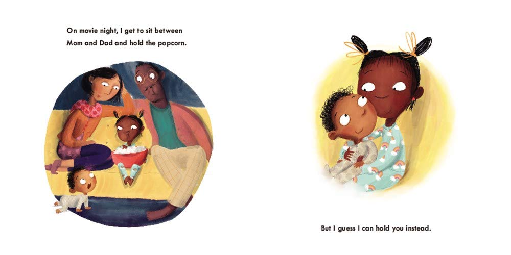 Open pages of "It's Big Sister Time" showing big sister holding baby and family sitting together with popcorn.