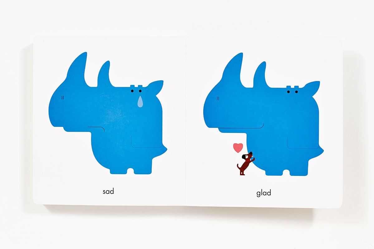 Open board book showing a blue rhinoceros with "sad" and "glad" expressions from Rhymoceros.