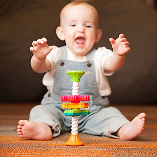 Baby reaching for colorful spinning propellers on corkscrew pole toy MiniSpinny for sensory play and learning.