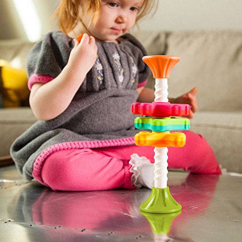 Child playing with colorful MiniSpinny toy featuring three vibrant propellers on a corkscrew pole for sensory learning.