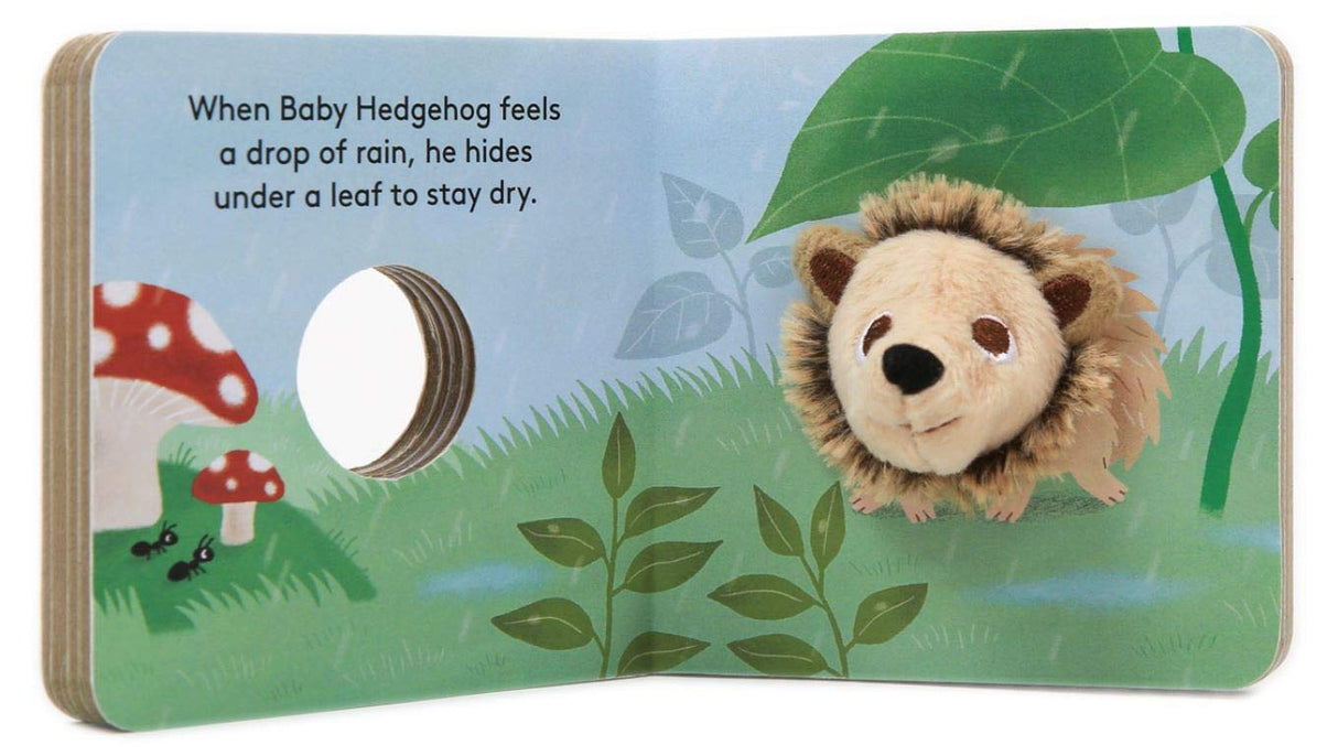 Open Baby Hedgehog with Finger Puppet board book showing plush finger puppet hedgehog in a colorful nature scene.