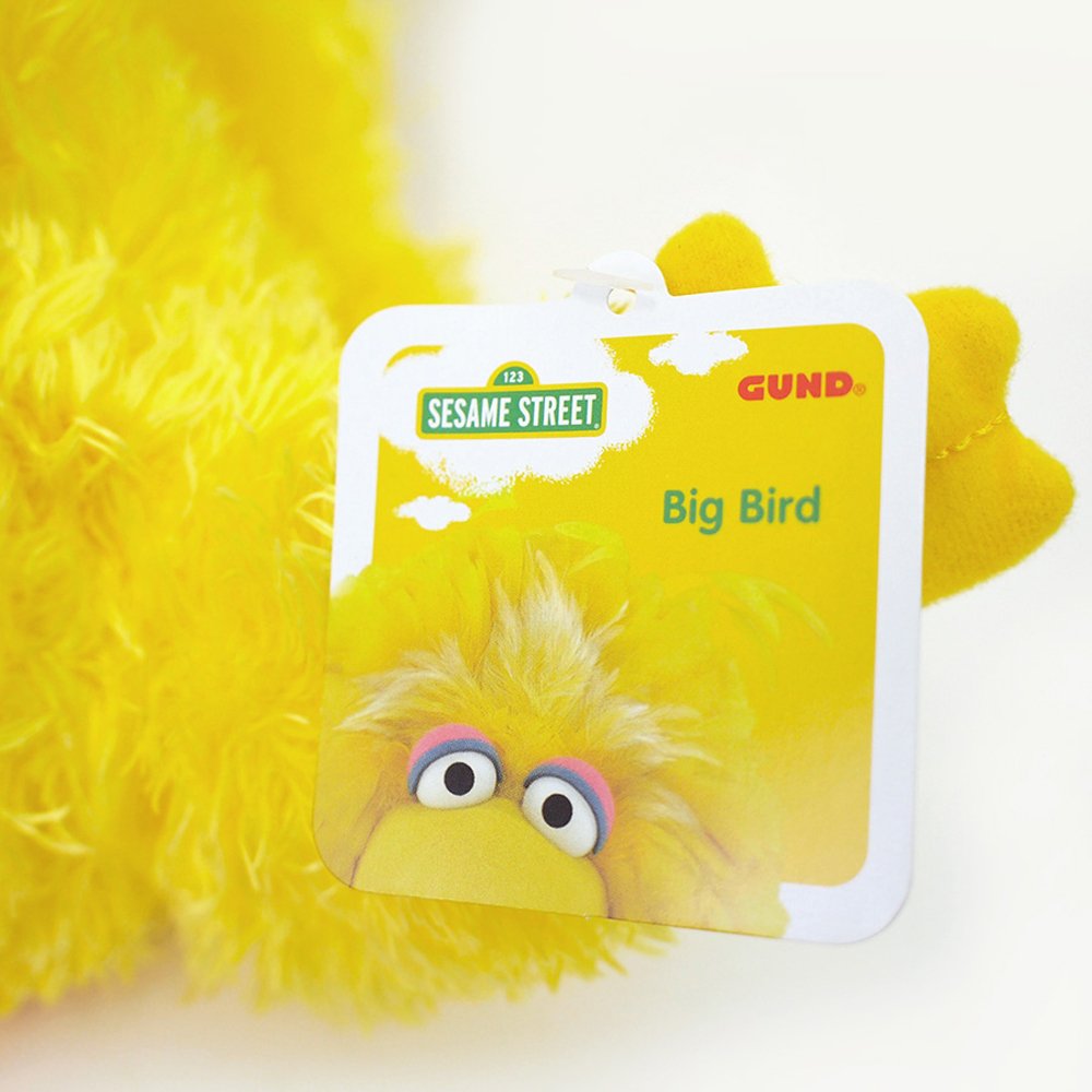 Big Bird plush tag featuring Sesame Street and GUND logos on a soft yellow plush background for the Big Bird product.
