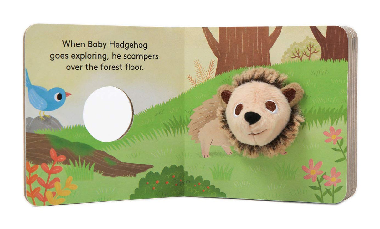 Baby Hedgehog with Finger Puppet board book open showing plush hedgehog puppet in colorful forest scene for ages 0-3.