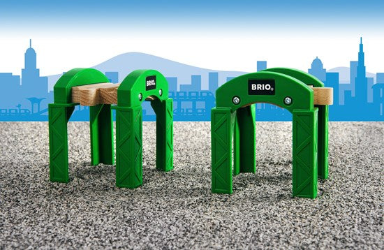 Two green BRIO Stacking Supports for building bridges and tunnels in a wooden railway set for kids ages 3 and up.