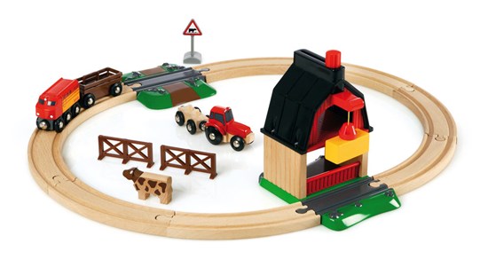 Farm Railway Set with wooden train track, red tractor, barn, hay crane, cow figure, and train wagon for farm play.