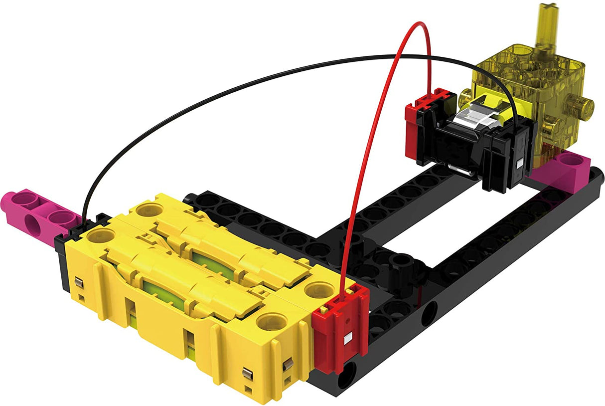 Easy Electric Circuits battery holder and motor connected with wires on a black building base for learning electricity.