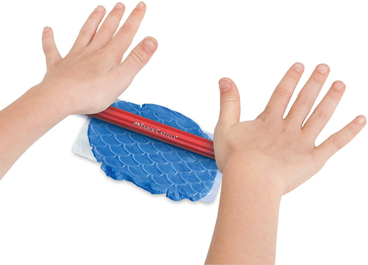 Create with Clay kit showing hands rolling blue modeling clay with a red tool on white surface.