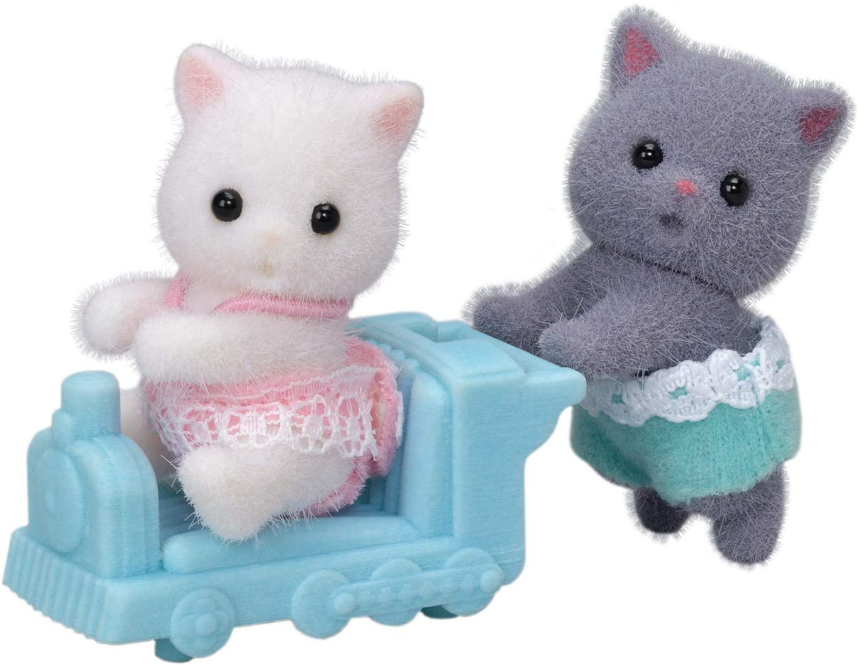 Persian Cat Twins featuring two fluffy kittens in fabric clothes with a blue ride-on toy train for imaginative play.