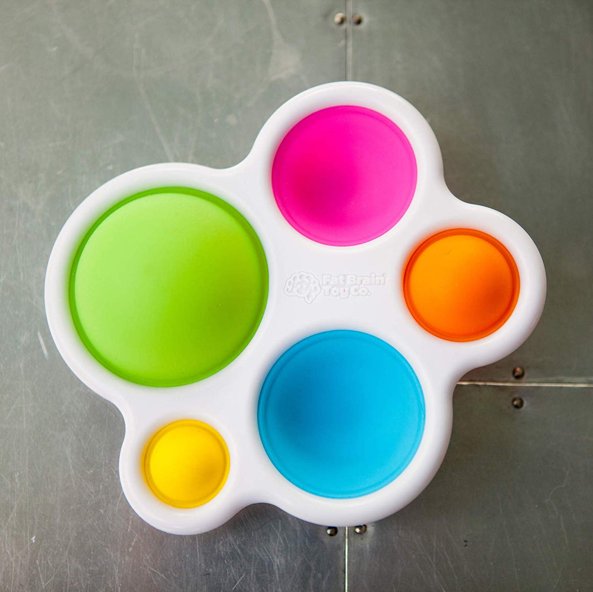 Dimpl sensory toy with colorful silicone bubbles in a sturdy white ABS frame for tactile play and fine motor skills development.