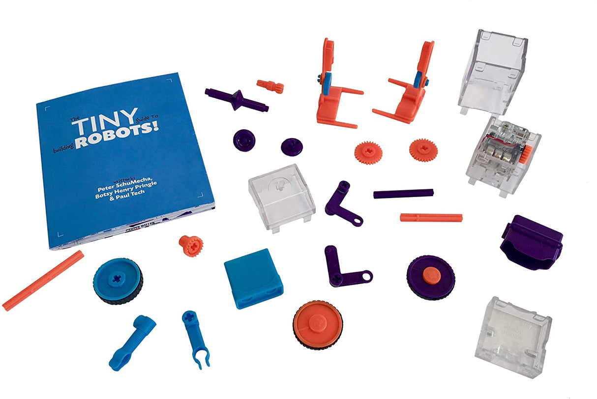 Tiny Tools Tiny Robots mini robotics kit parts including gears, axles, chassis pieces, and instruction manual for building robots.