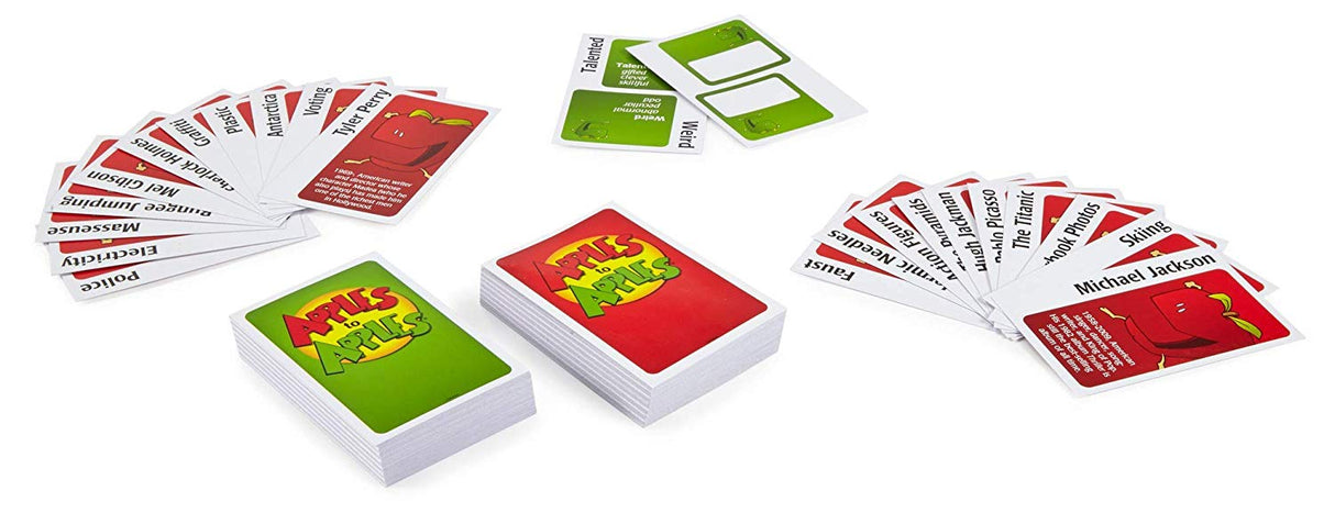 Apples to Apples card game showing red Thing cards and green Description cards spread on a white surface.