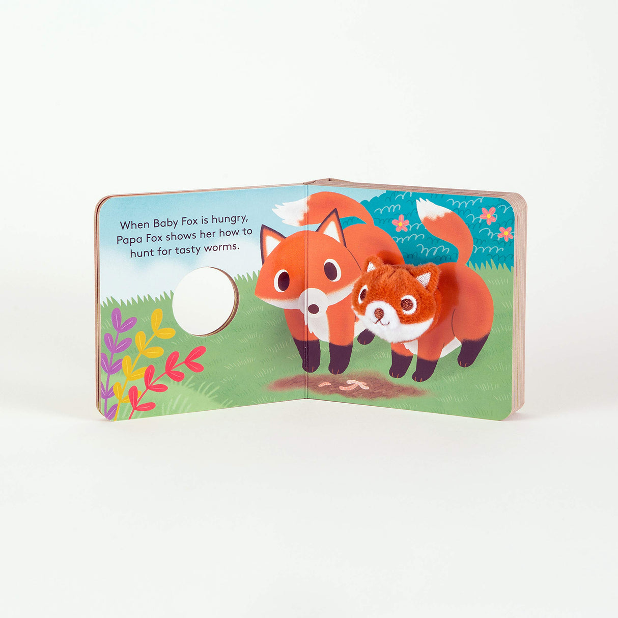 Baby Fox with Finger Puppet board book open to a page with a baby fox illustration and a plush finger puppet attached.