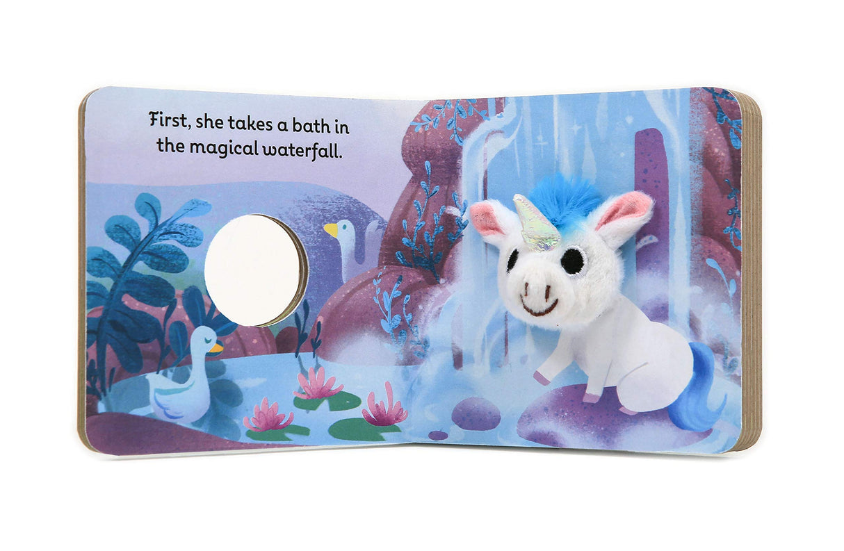 Baby Unicorn with Finger Puppet board book open to a magical waterfall scene with plush finger puppet attached.