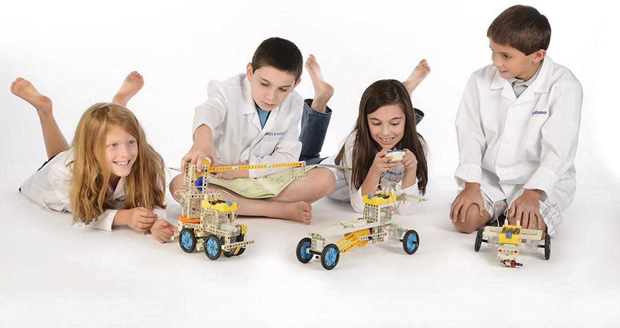 Children building and controlling motorized vehicles with Remote Control Machines kit using wireless remotes.