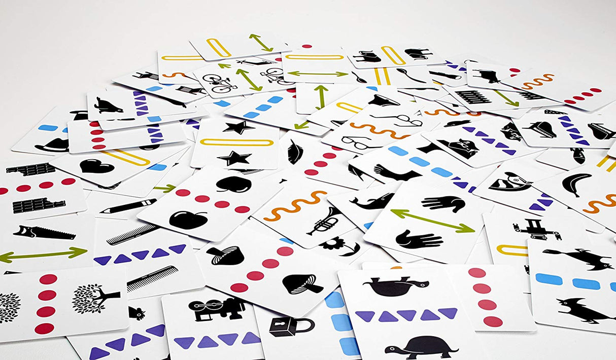 Anomia Kids card game spread out showing various colorful symbols and images for quick thinking family fun.