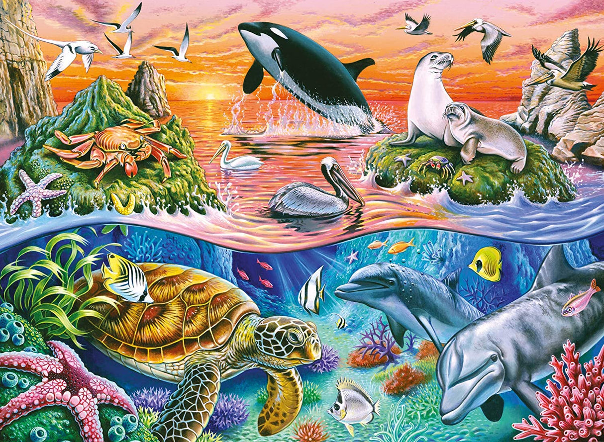 100pc Beautiful Ocean Puzzle showing vibrant sea life with dolphins, sea turtles, seals, birds, and colorful coral at sunset.