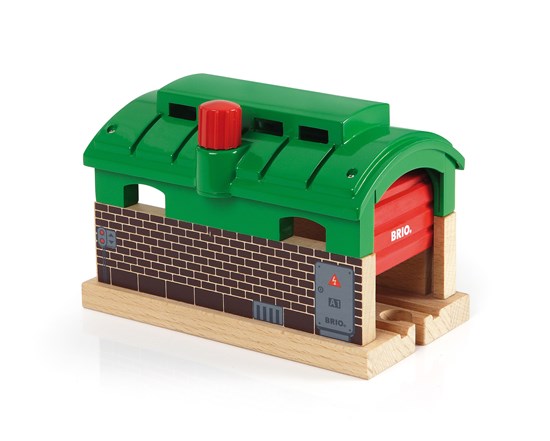 Train Garage toy with green roof and red door, serving as a resting spot or tunnel for BRIO trains Ages 3+