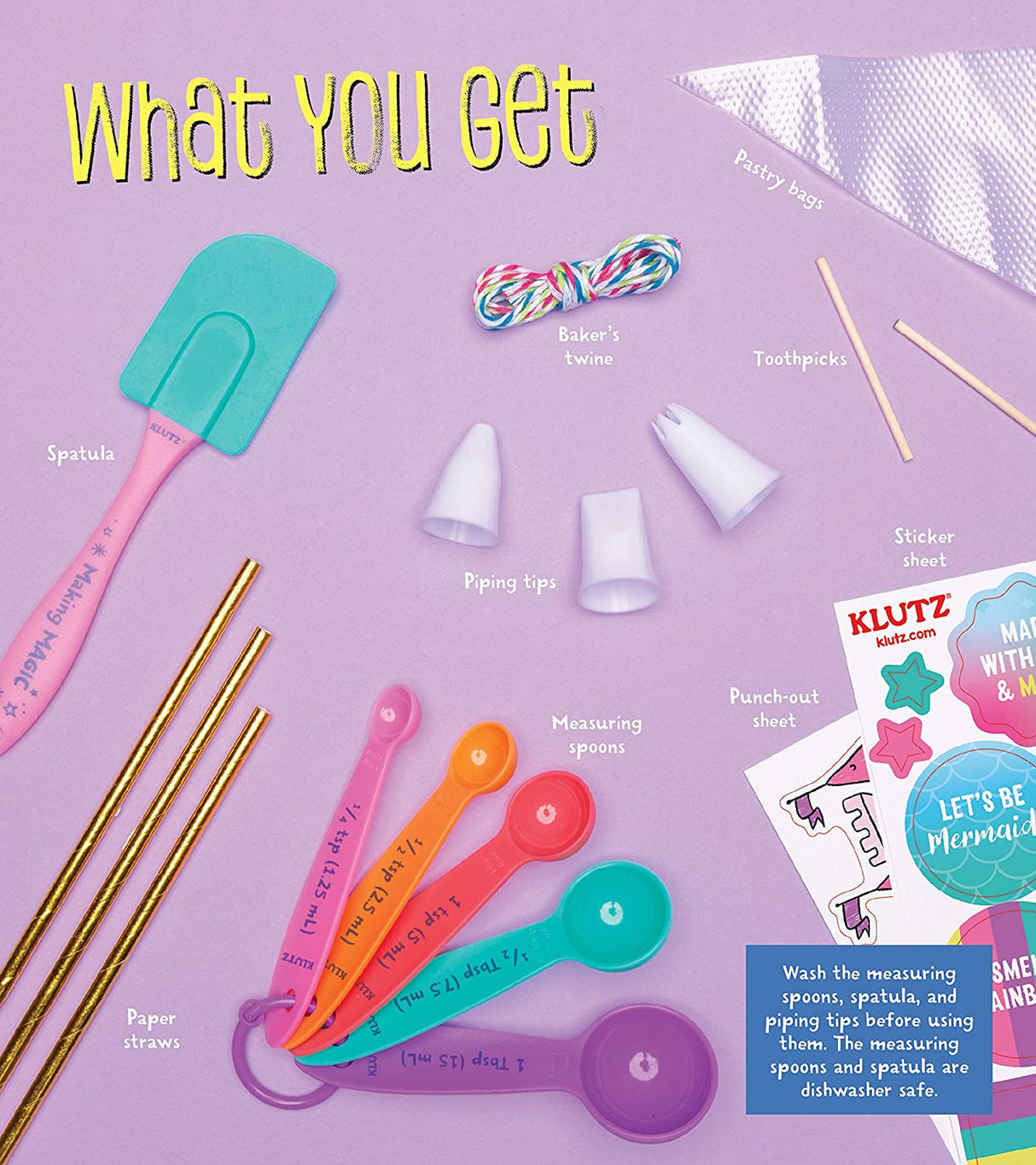 Kids Magical Baking kit with colorful spatula, measuring spoons, piping tips, twine, straws, and stickers on purple background.