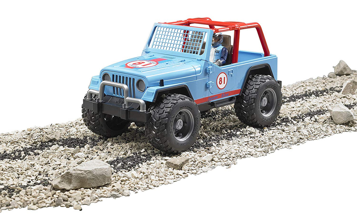 Jeep Cross Country Racer toy with large off-road tires and protective shield driving on rocky terrain.