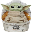 Star Wars The Child plush toy featuring The Mandalorian character with big ears and soft beige clothing in packaging.