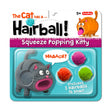 Hairball Kitty squeeze toy with three colorful pom pom hairballs that shoot when pressed, perfect for kids 5 and up.