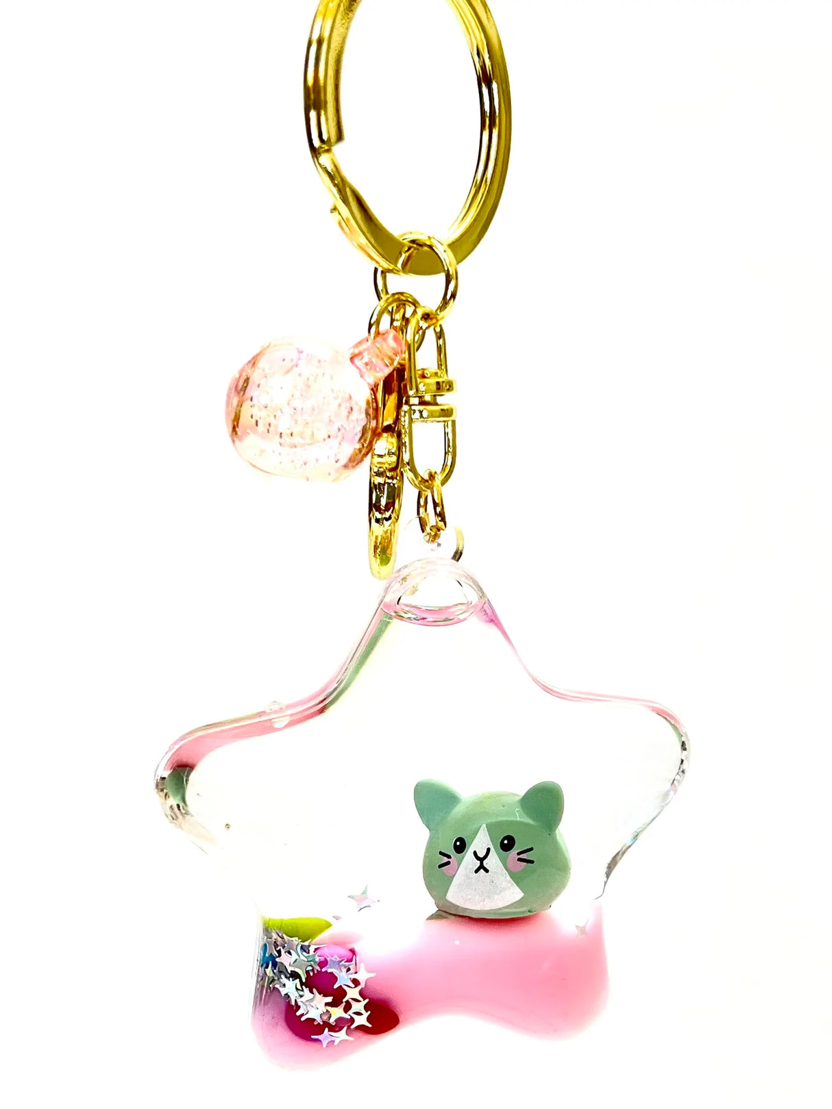Clear star-shaped Kitty Star Keychain with a green cat figure and gold keyring clip accessory.