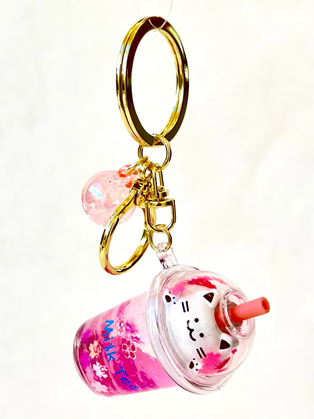 Kitty Boba Milk Keychain with a pink cat-themed boba cup and gold keyring, perfect for bags or keys.