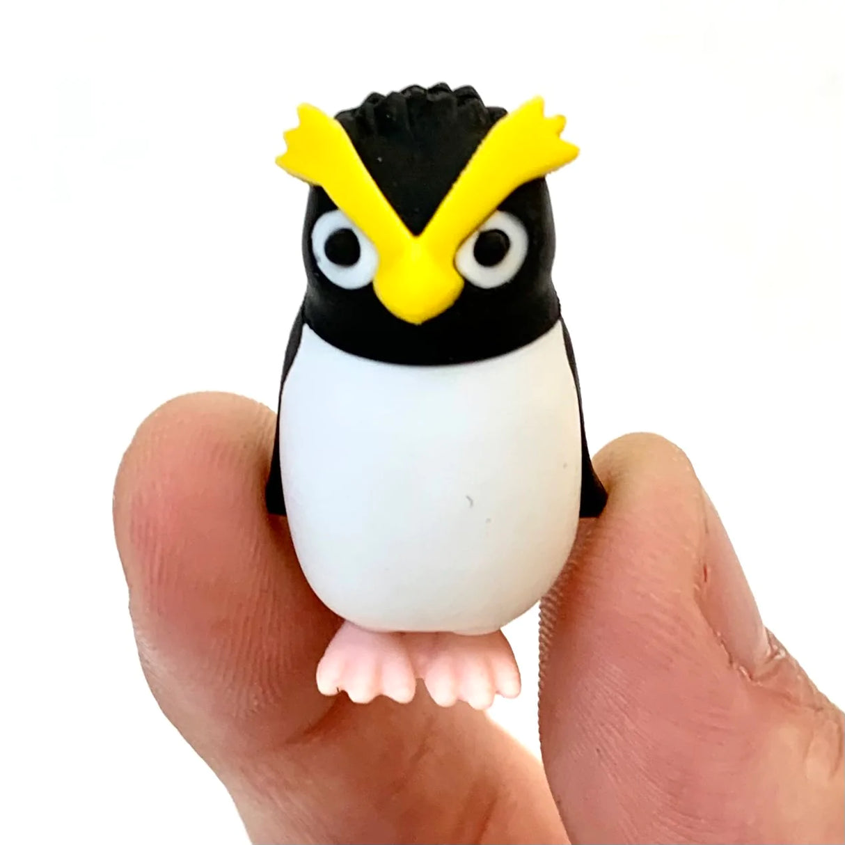 Japanese Eraser Sea Friend showing a small black and white penguin eraser held between fingers.