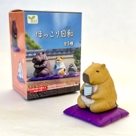 Tea Time Animal Blind Box featuring a cute capybara enjoying tea on a purple cushion collectible figure.