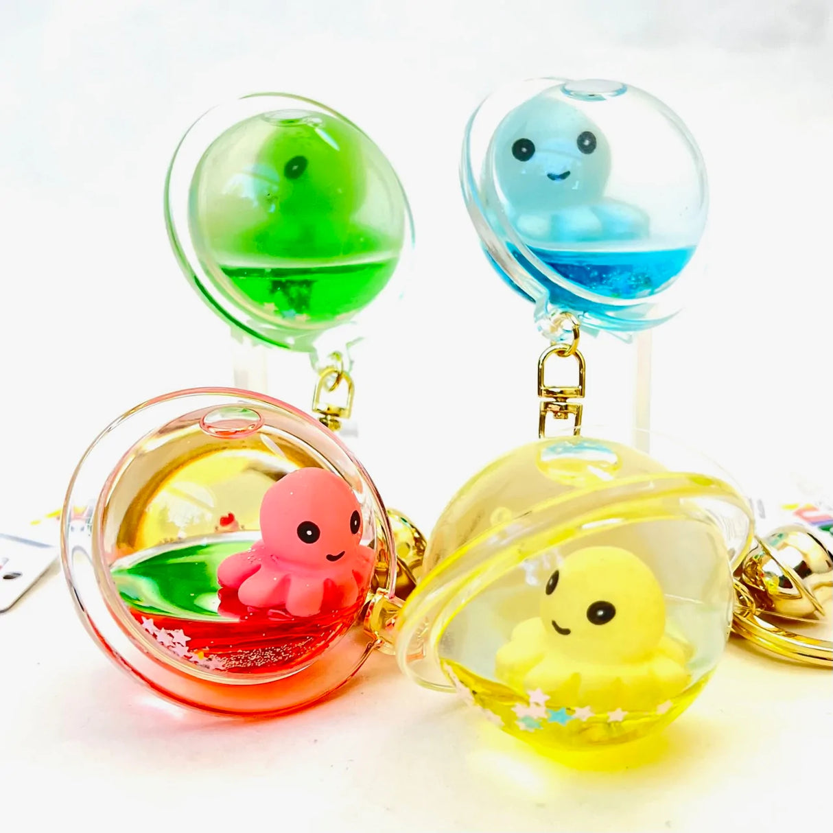 Octopus Floaty Keychain with colorful floaty octopus inside transparent bubble, attached with clip and keyring for easy use.