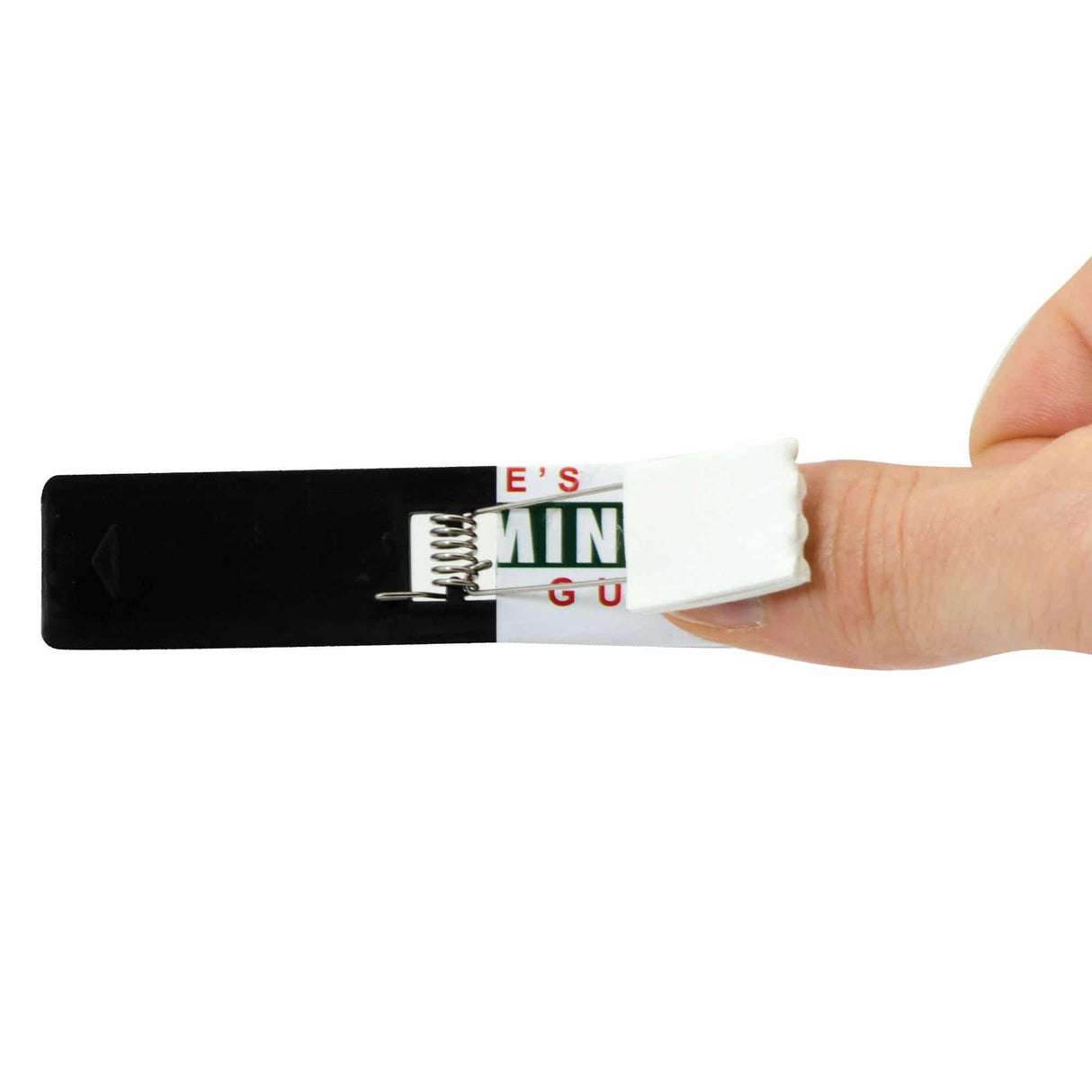 A hand pressing the spring inside a Snappy Gum pack for a fun surprise prank.