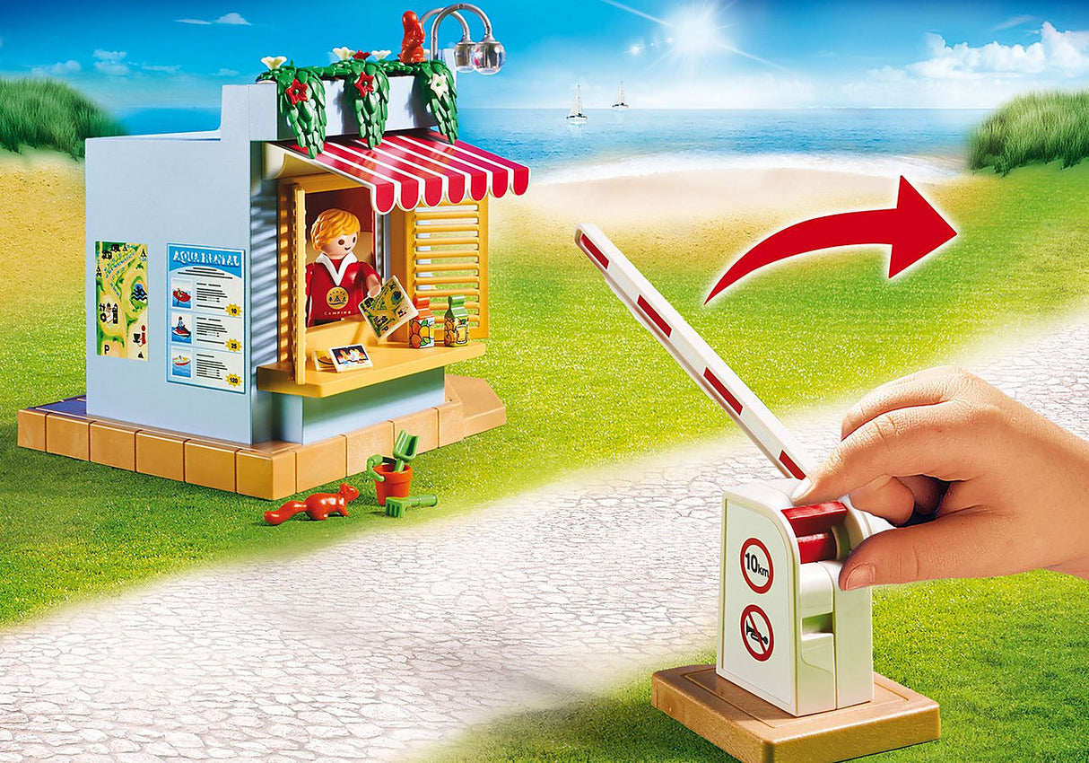 Family Fun | Campground showing the kiosk and a hand lifting the entrance barrier on a sunny beach path.