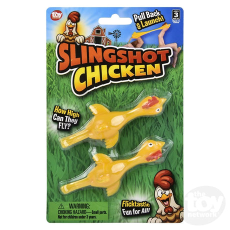 Slingshot Chicken 2-pack toy with yellow chickens on green grass background, pull back and launch for fun.
