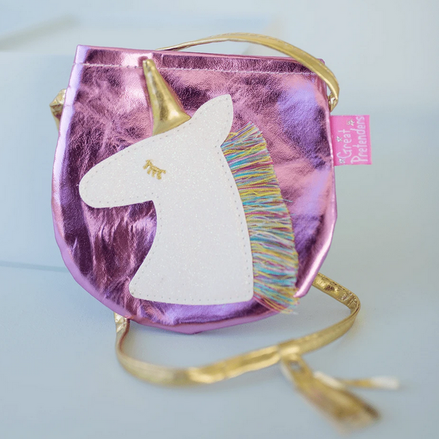 Fancy Unicorn Purse in shiny pink with a golden horn, multicolored fringe mane, and a golden shoulder strap.