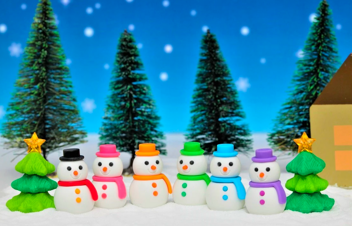 Japanese Eraser Snowman or Tree puzzle erasers in colorful scarves with green tree erasers and snowy background.