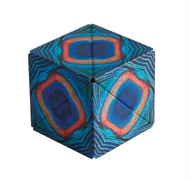 Shashibo | Wings magnetic puzzle cube showing colorful geometric patterns with blue and orange design.