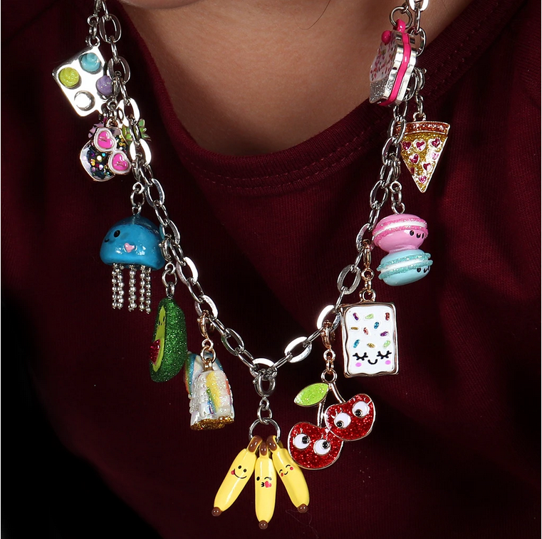 Close-up of Banana-moji Charm with funny faces on a silver chain necklace for kids customization.
