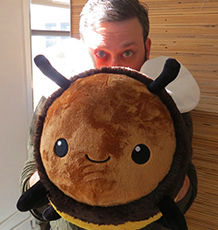 Fuzzy Bumblebee plush toy, soft and friendly, perfect for kids aged 3 and up, featuring a cute smiling bee design.