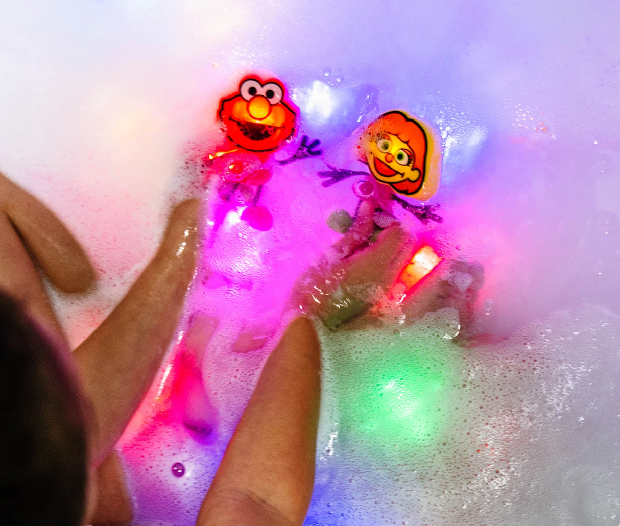 Glo Pals Elmo Character lighting up in a bubbly bath with reusable light-up cubes for kids aged 3 and up.
