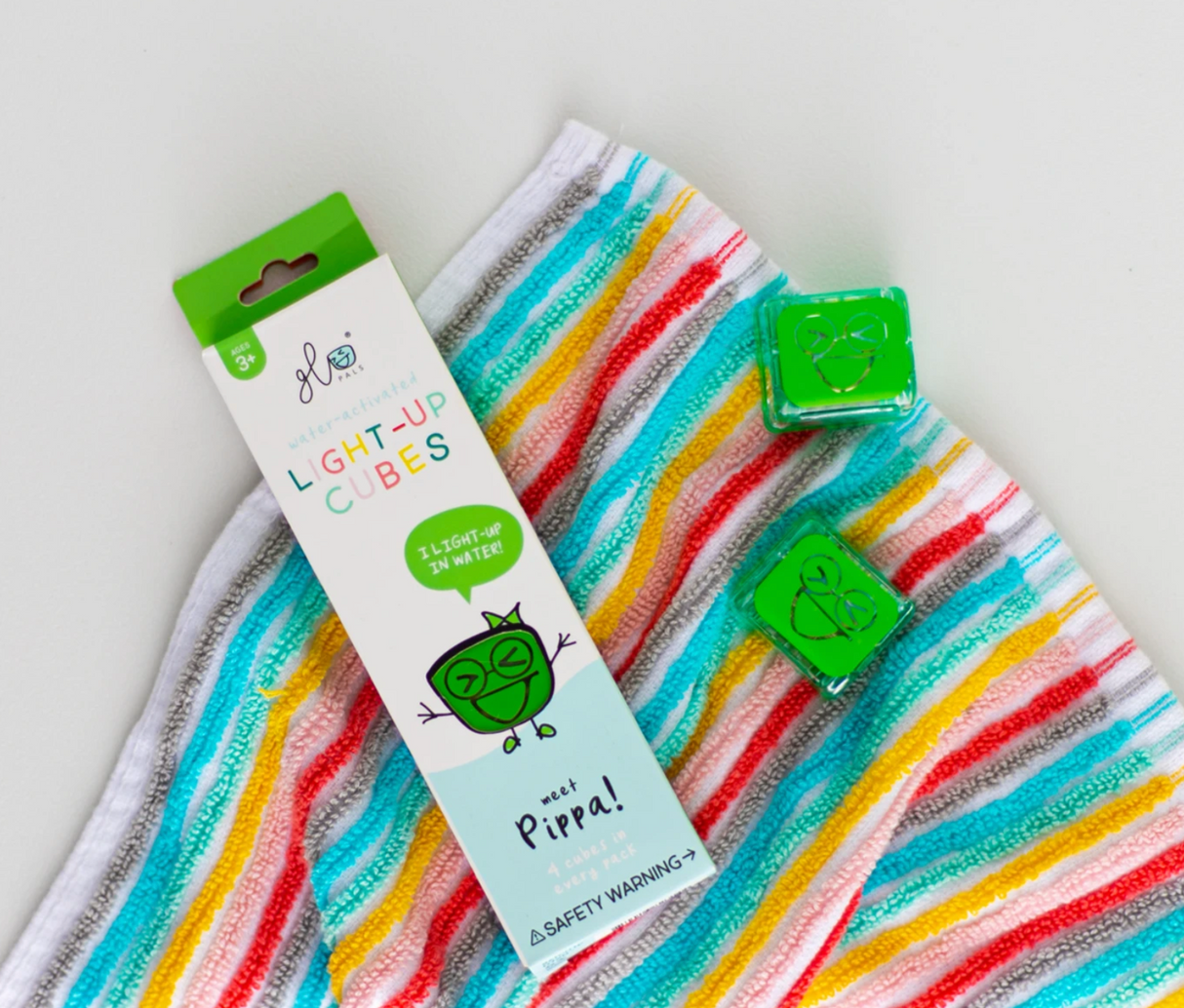 Glo Pals Green light-up cubes with Pippa character on colorful striped towel for kids ages 3 and up.