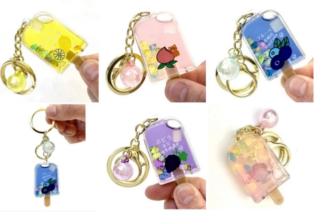 Fruit Popsicle Keychain in assorted colors with detailed fruit designs, key ring, and clip for bags or keys.