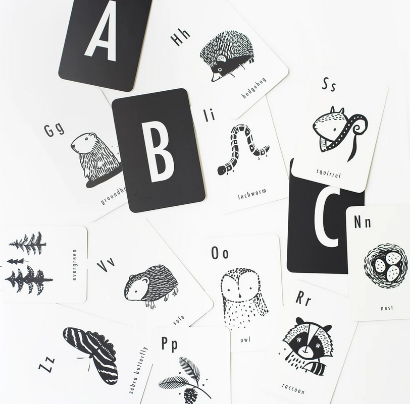 Woodland Alphabet Cards featuring black and white animal and nature illustrations with bold letters for learning.