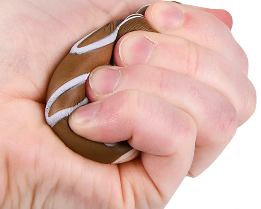 Hand squeezing a brown 3-inch Squishy Donut with white icing, soft and slow rising for stress relief.