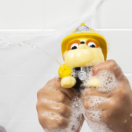 Paw Patrol Bath Squirter held in hands squirting water with soap bubbles during bath playtime.