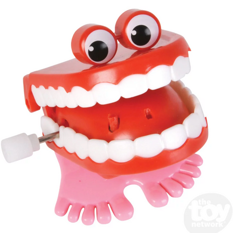 Chatter Teeth wind-up toy with red lips, white teeth, googly eyes, and pink feet, approx 2 inches tall.