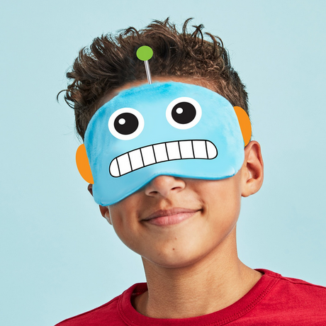 Boy wearing a soft fleece Eye Mask Robot with antennae and elastic strap against a blue background.