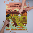 1000pc Geometric New Hampshire Puzzle showing nature scenes with animals and outdoor activities in warm tones.
