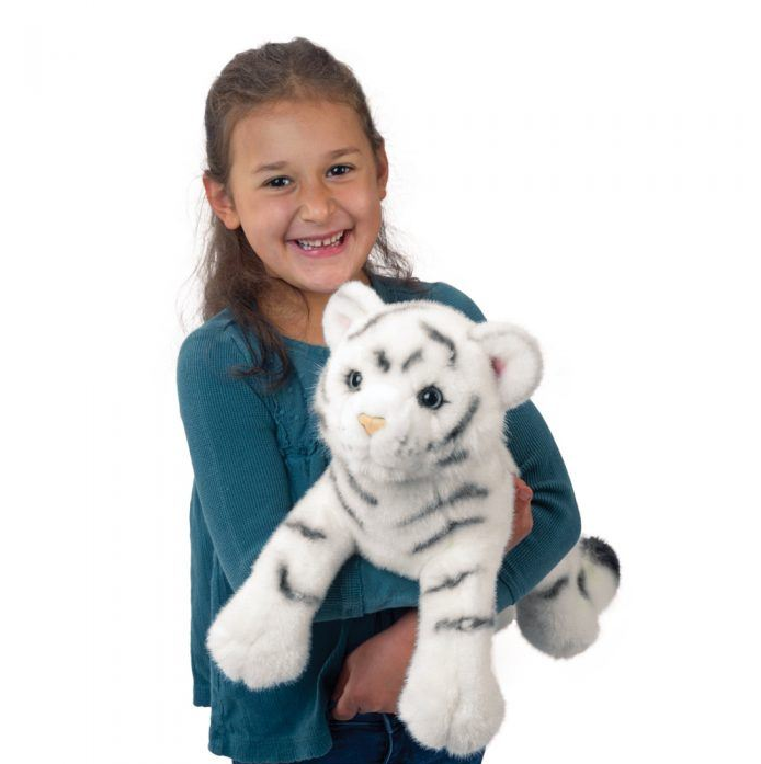 Smiling child holding White Tiger Zahara plush toy with soft white fur and gray stripes, featuring blue eyes and huggable design.