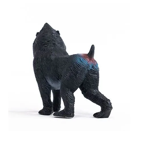 Mandrill toy showing black textured fur and colorful markings on the back, standing and facing away.