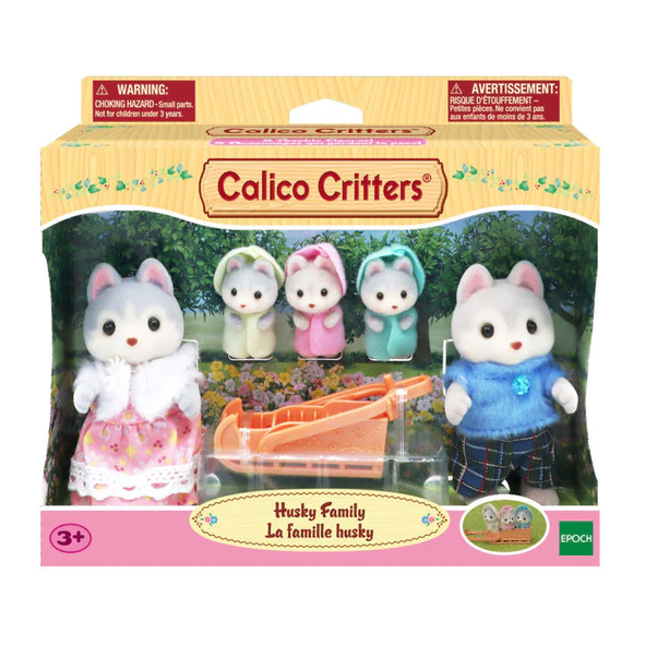 Calico Critters Husky Family set with five gray and brown husky figures and a bright orange sleigh toy.